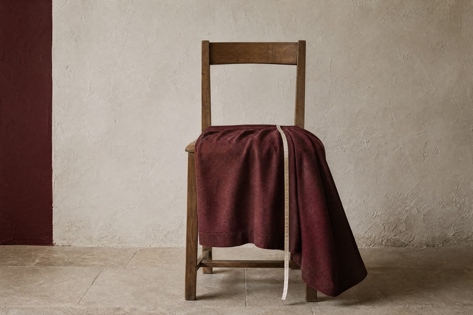 A midi skirt draped over a chair with a measuring tape running from the seat edge to the hem.