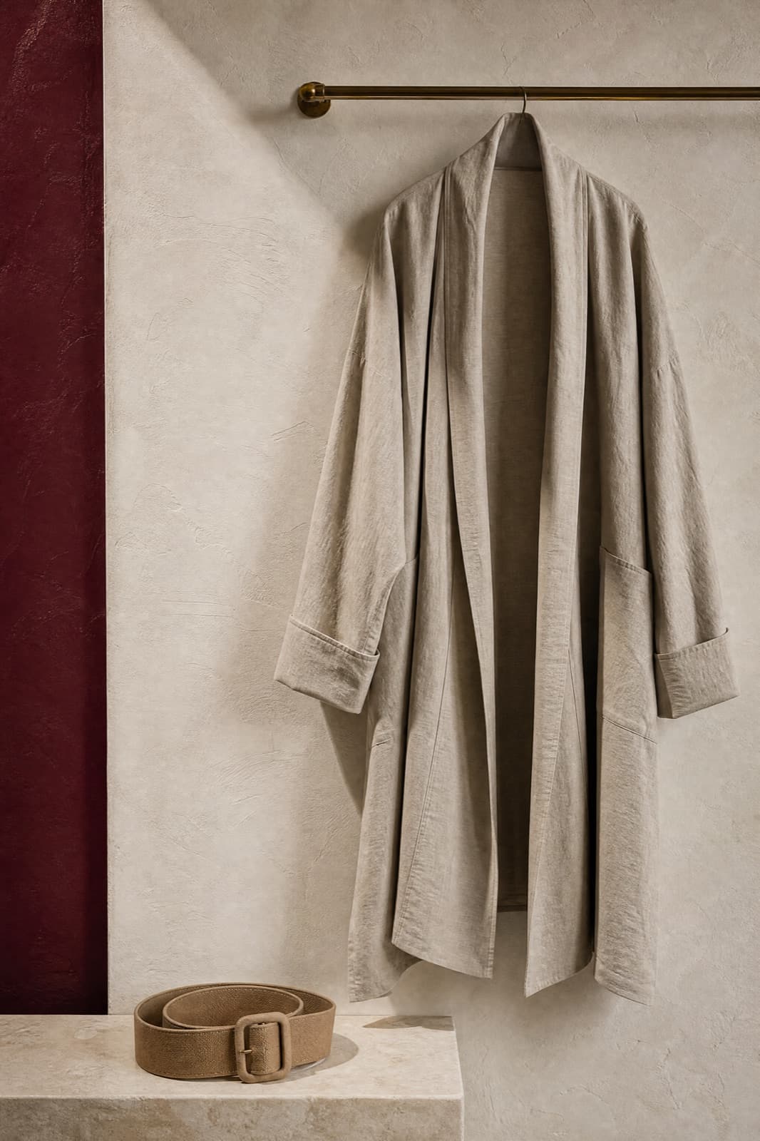 Fabric Belt, hung from a rail against limestone plaster.